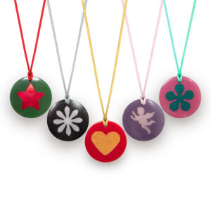 Five circular pendant necklaces with colored cords - green with red star, black with white flower, red with gold heart, purple with pink angel, pink with green clover