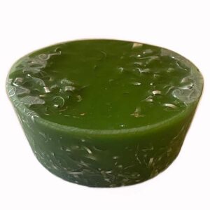Green cylindrical orgonite towerbuster with metal shavings visible throughout, photographed against white background